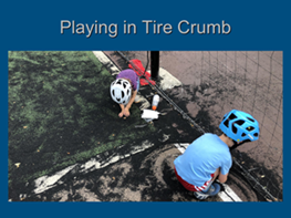 Children playing in tire crumb infill from field